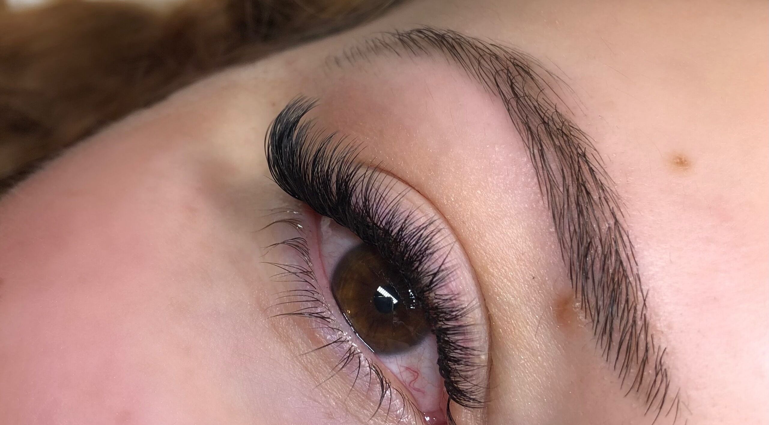 Close-up of enhanced lashes at Hennylash, London, England, GB showcasing meticulous beauty treatment.