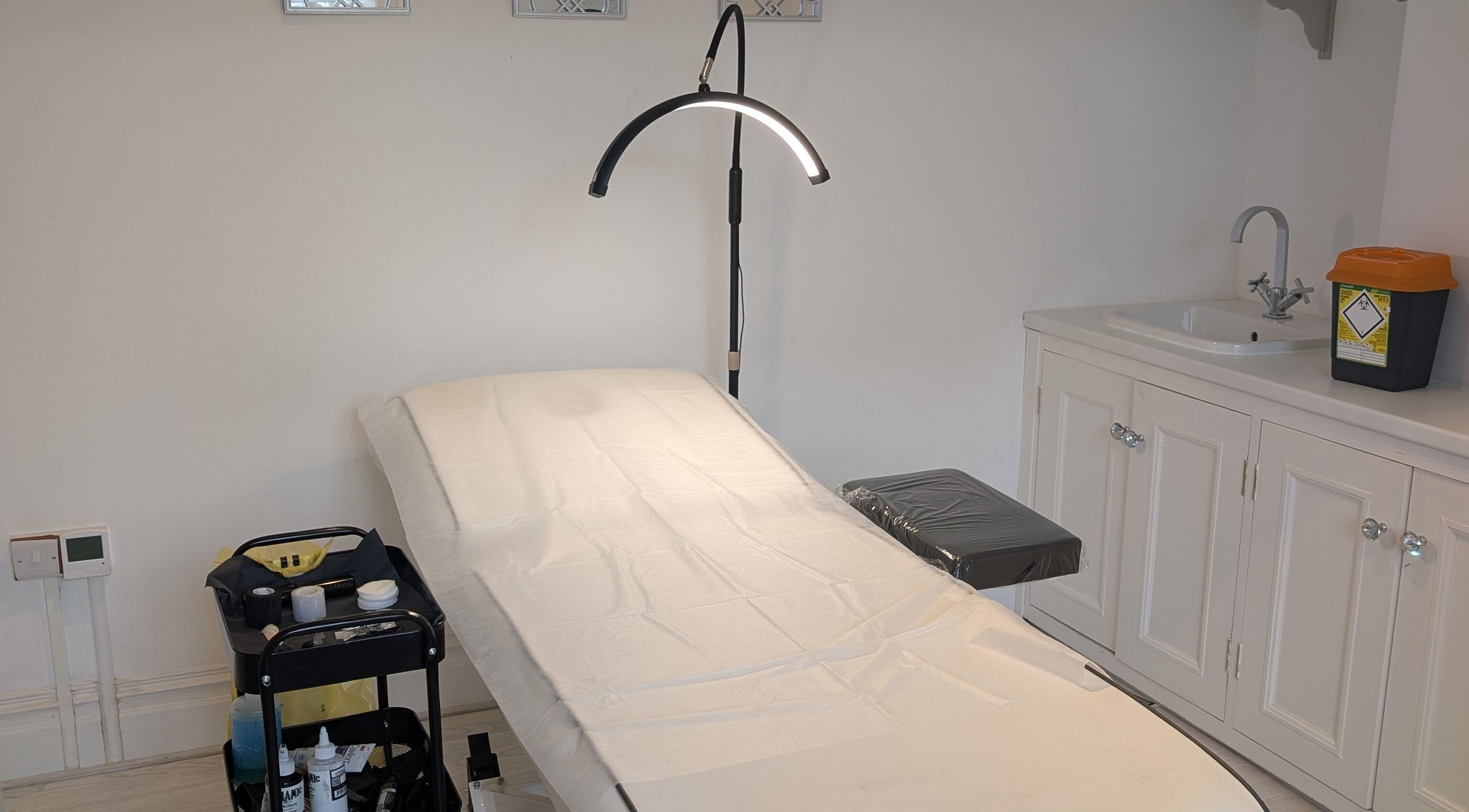 Clean, professional treatment room at All Things Ink by Kaydee, Clitheroe, England, GB, featuring a tattoo bed.