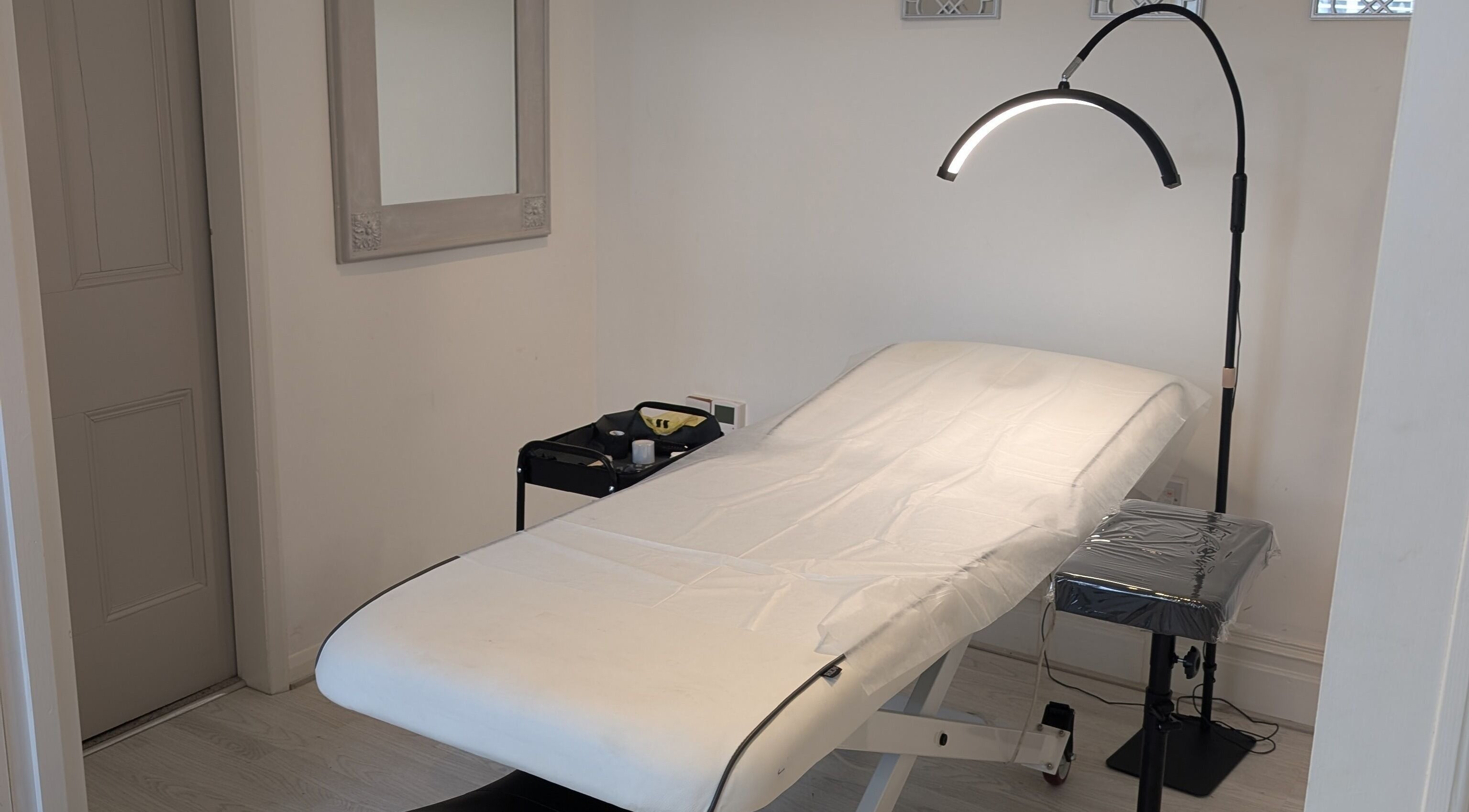 Treatment room at All Things Ink by Kaydee in Clitheroe, England, GB, featuring a massage bed and sleek lighting.