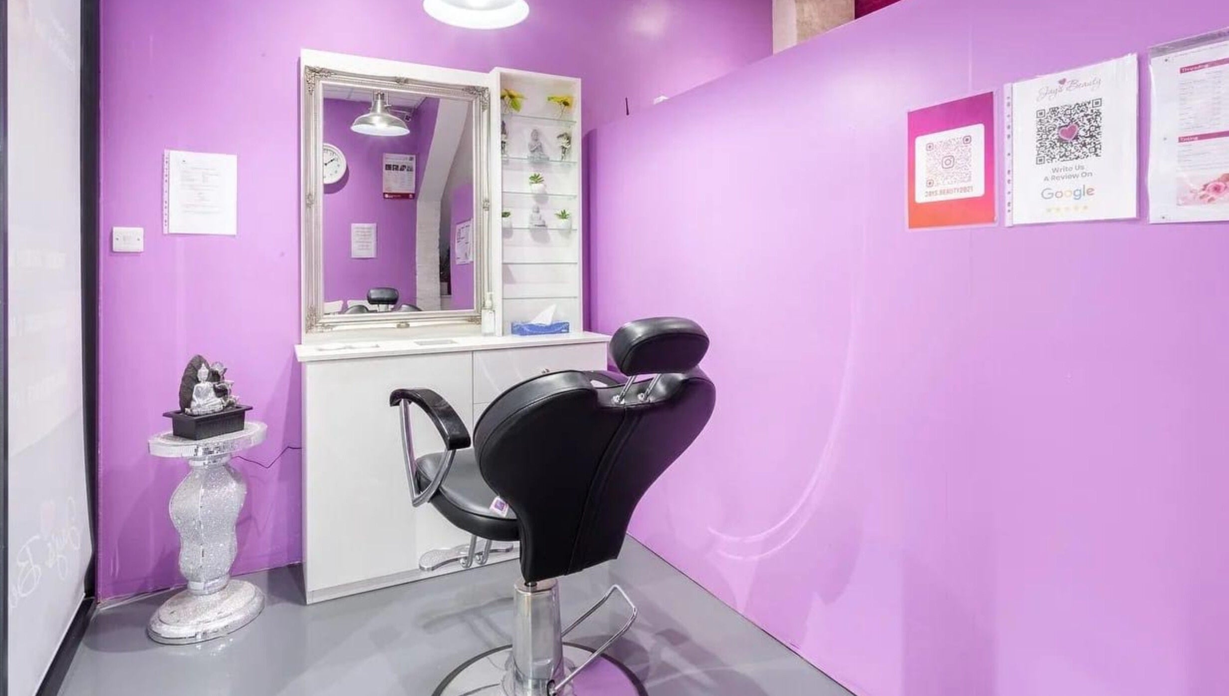 Elegant salon setup at Jay’s Beauty - Ladies Only in Hounslow, England, GB with purple walls and modern styling chair.