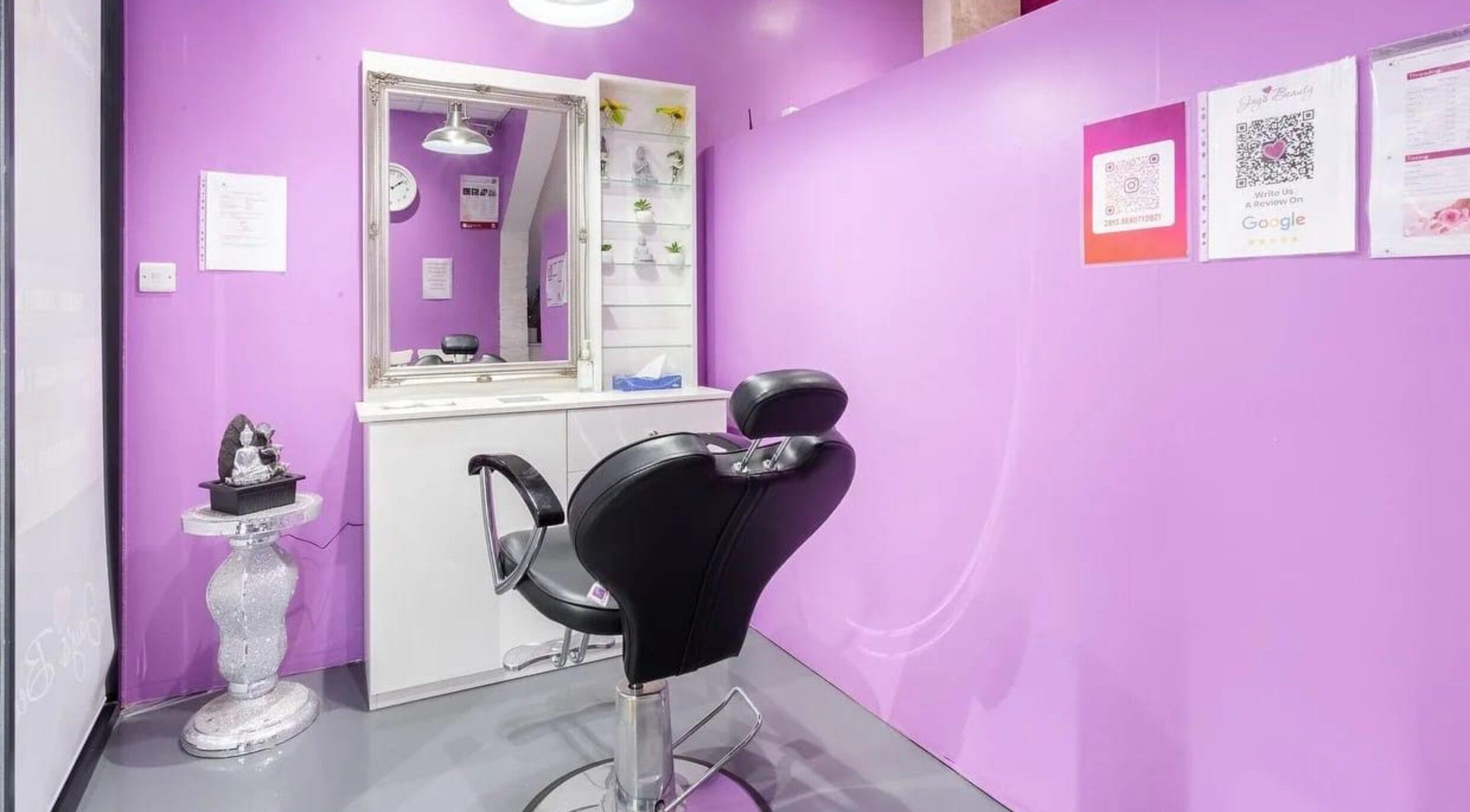 Elegant salon setup at Jay’s Beauty - Ladies Only in Hounslow, England, GB with purple walls and modern styling chair.