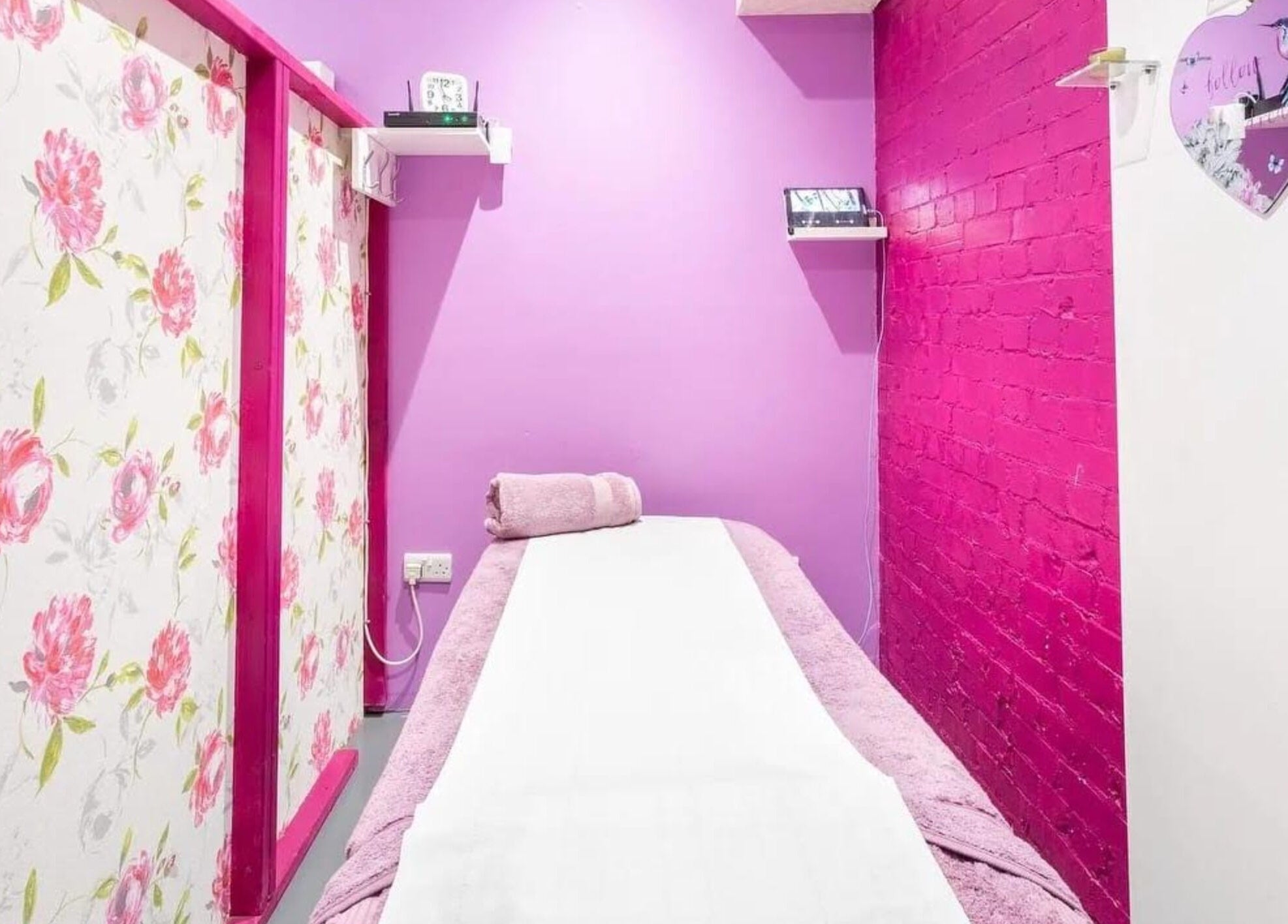 Relaxing treatment room at Jay’s Beauty - Ladies Only in Hounslow, England, UK with floral and pink decor.