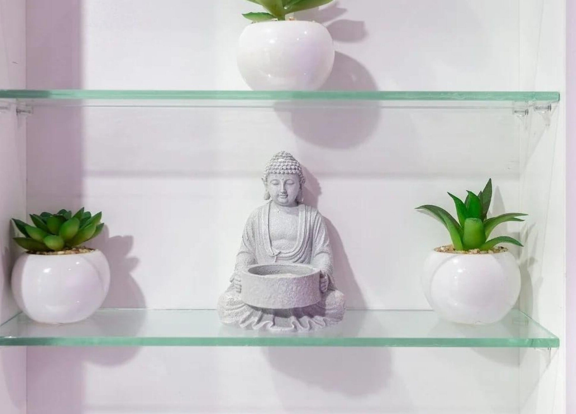 Elegant Buddha statue and plants at Jay’s Beauty - Ladies Only, Hounslow, England, GB.