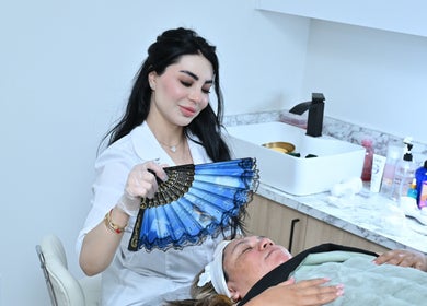 Aesthetician provides relaxing spa treatment at Laura's Beauty Touch, Rego Park, NY, US.