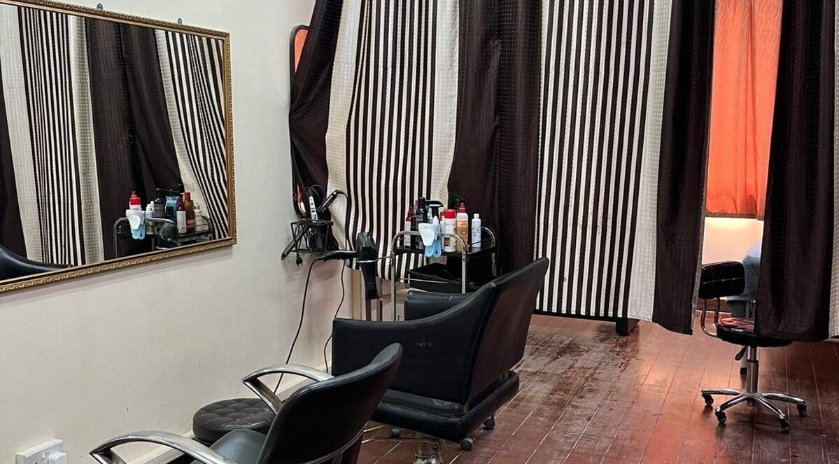 Professional styling area at Mythili's Salon & Beauty Parlour in Singapore, SG featuring sleek black chairs.