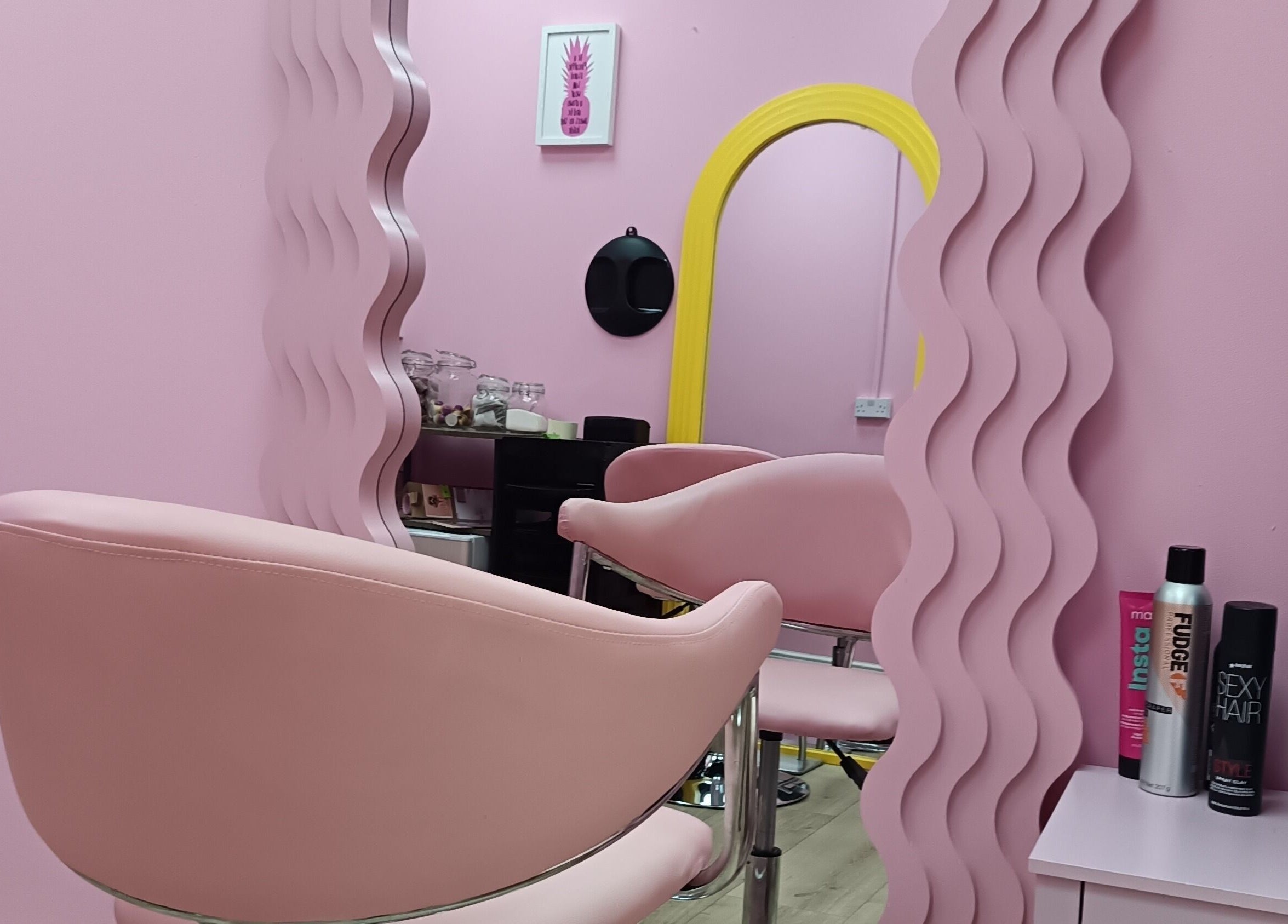 Chic pink salon chair and mirror at Franks, Cheadle, England, GB.