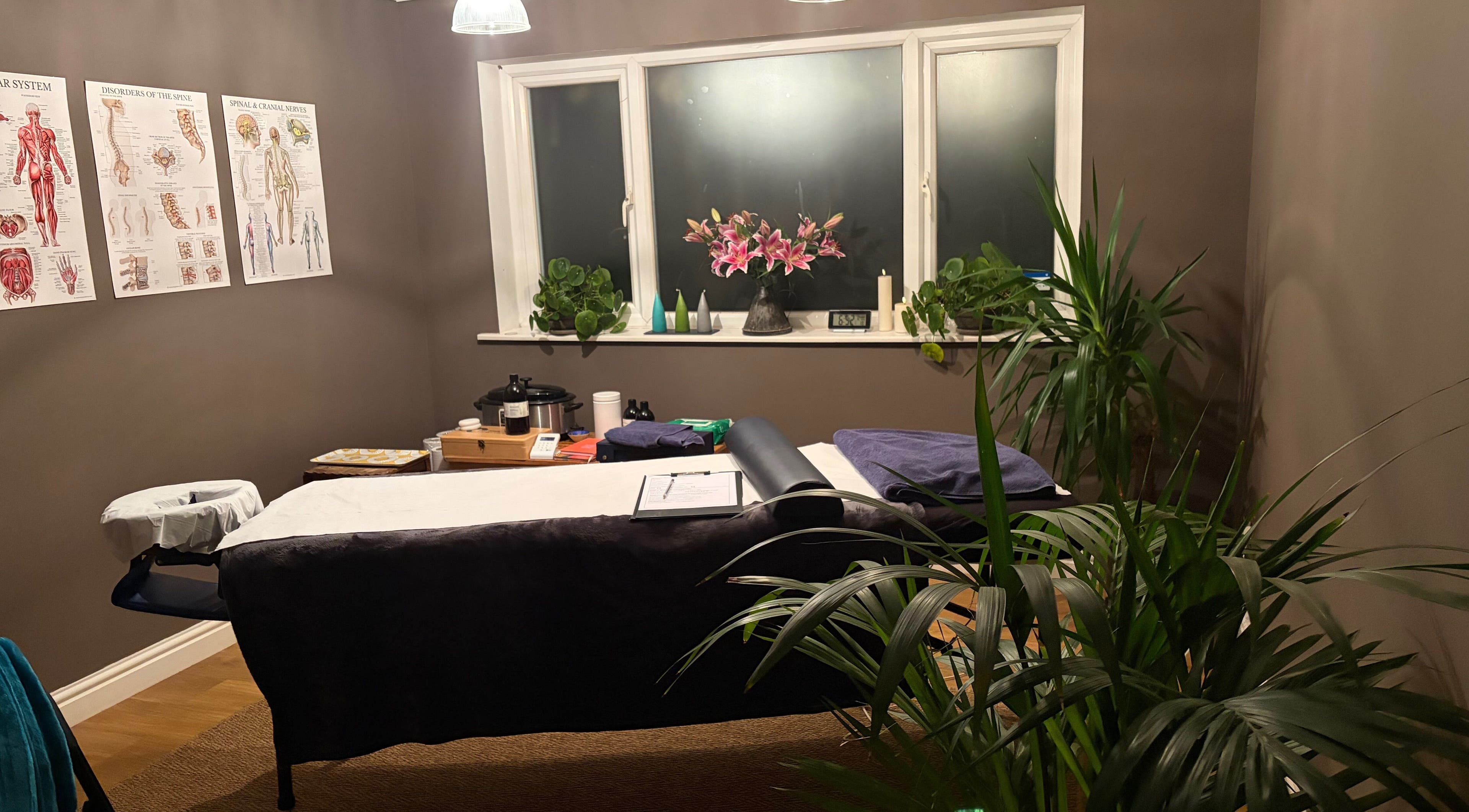 Phoebe’s Recovery Zone massage room in Goodrich, England, GB with a treatment bed and relaxing decor.