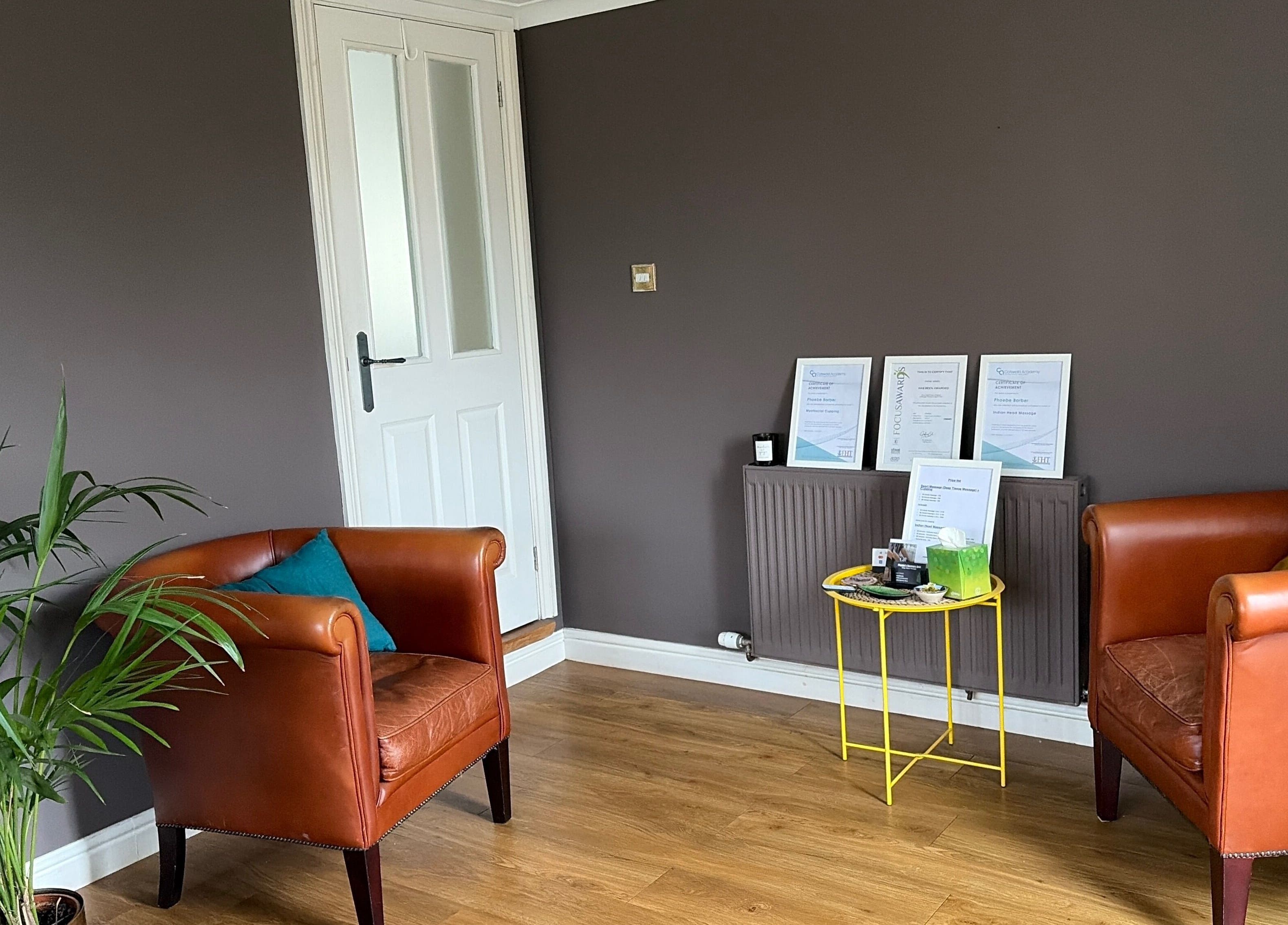 Inviting seating area at Phoebe’s Recovery Zone, Goodrich, England, with stylish chairs and plants.