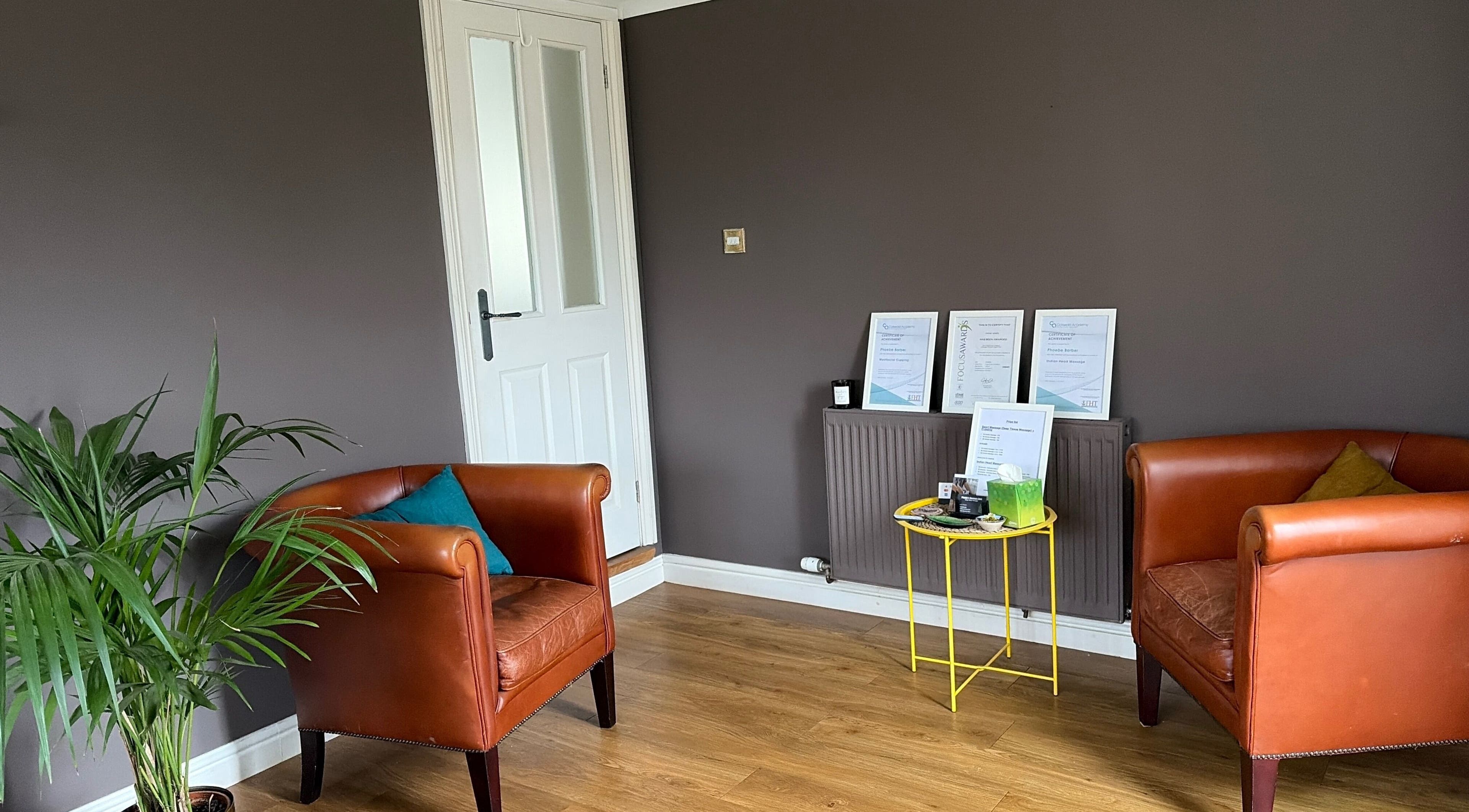 Inviting seating area at Phoebe’s Recovery Zone, Goodrich, England, with stylish chairs and plants.