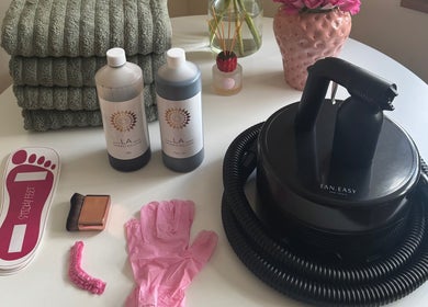Tanning equipment and supplies at Bronzed by Chlo, Manchester, England, GB, featuring tanning solutions and a spray gun.