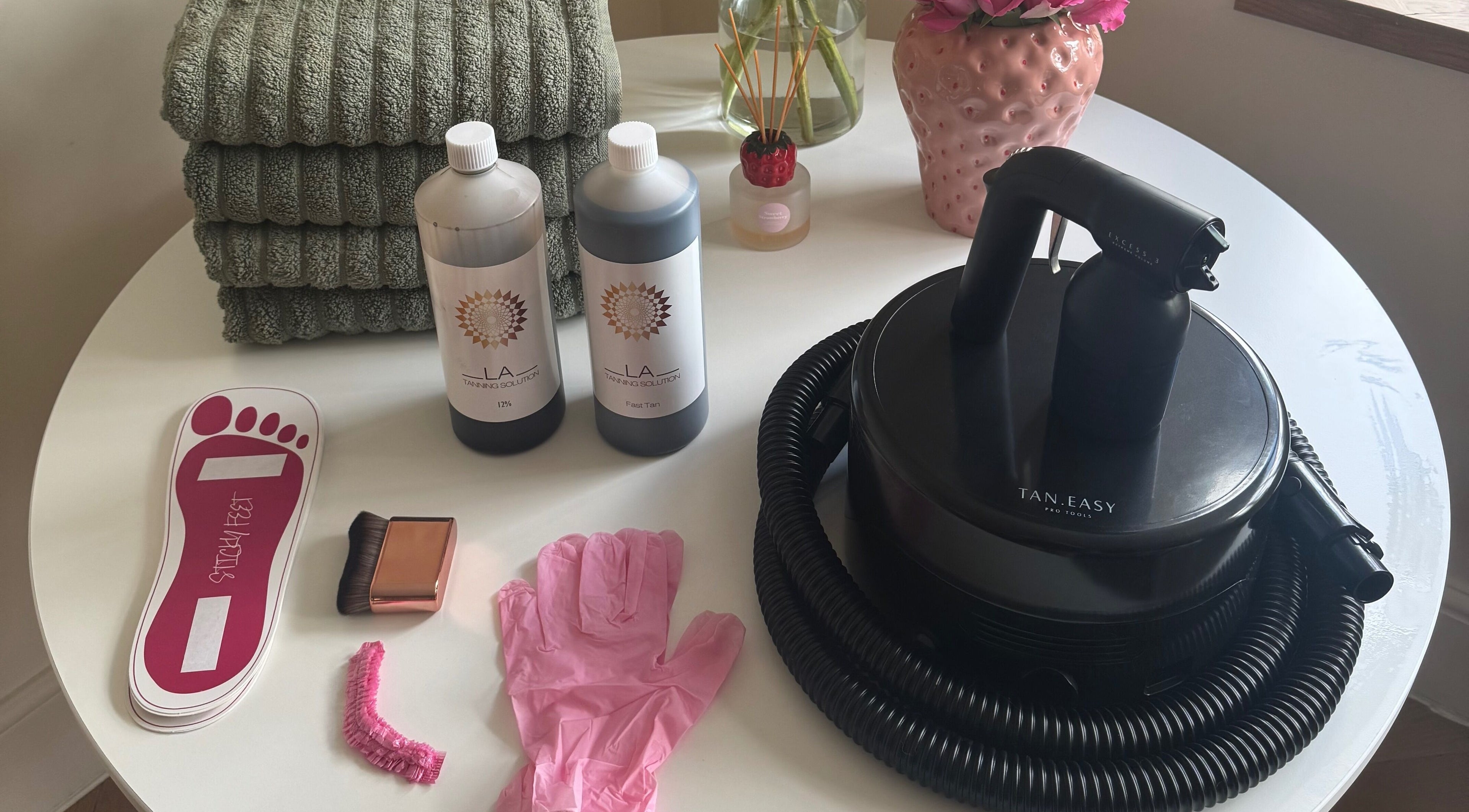 Tanning essentials at Bronzed by Chlo, Manchester, England, GB include solutions, spray machine, and accessories.