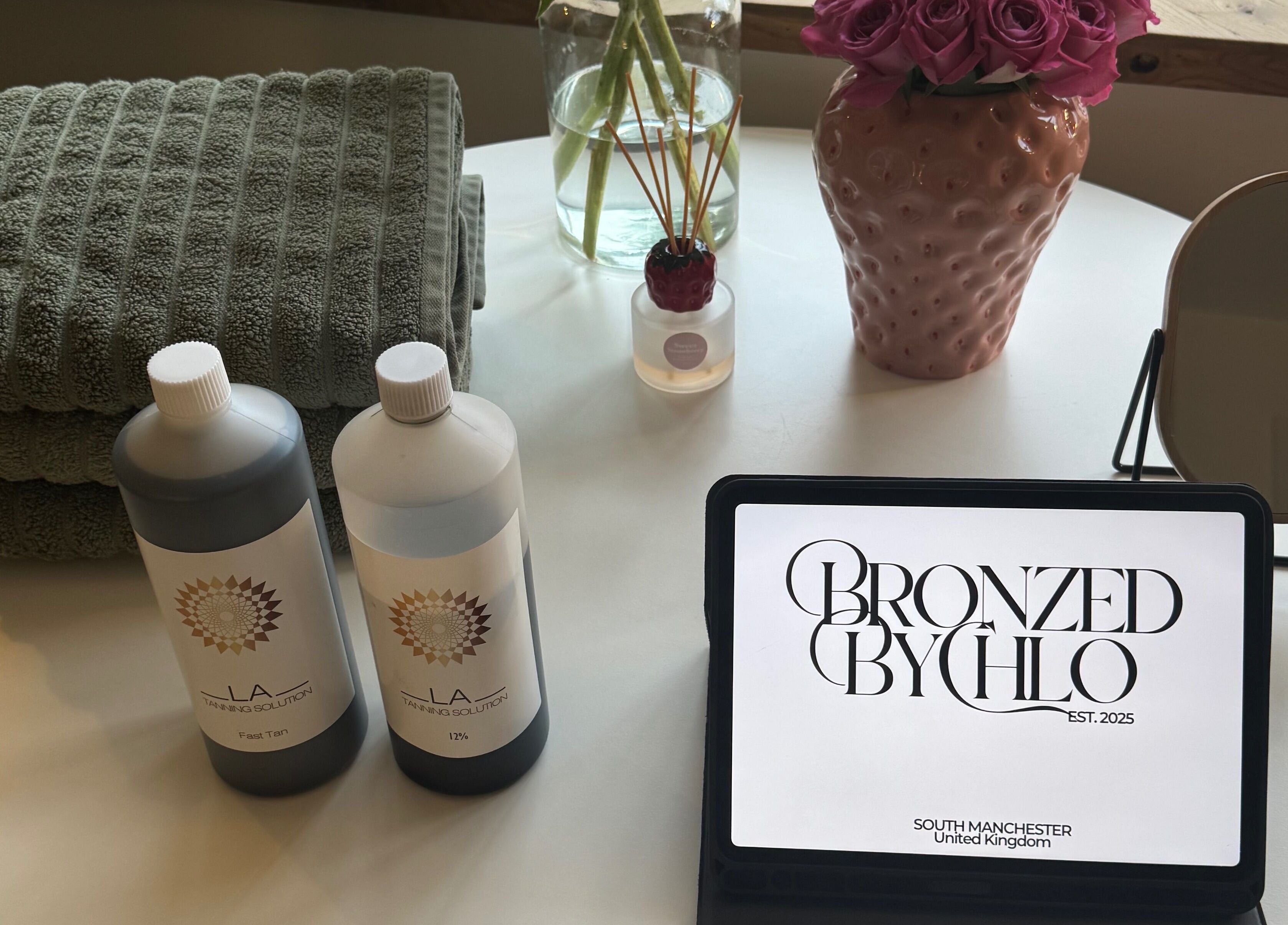 Elegant table at Bronzed by Chlo with products and flowers in Manchester, England, GB.