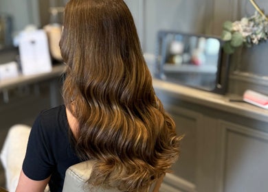 Elegant long wavy hair styled at SC Hair Extension Specialist, Euxton, England, GB. Perfect for a sophisticated look.