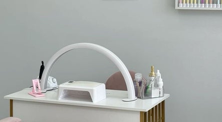 Nail station at Adorné Nails in Airdrie, Alberta, CA with tools and polish display for a chic ambience.