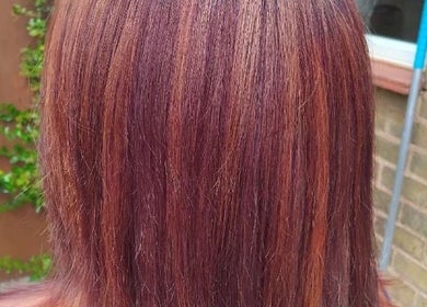 Rich copper hair color treatment at Chlos hair, Newport, England, GB. Highlighting glossy, smooth finish.