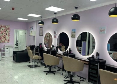 Modern interior of Indulgence Beauty and Hair Salon in Salford, England with chic decor and styling stations.