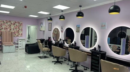 Modern interior of Indulgence Beauty and Hair Salon in Salford, England with chic decor and styling stations.
