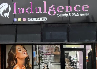 Front signage of Indulgence Beauty and Hair Salon in Salford, England, GB showcasing services offered.