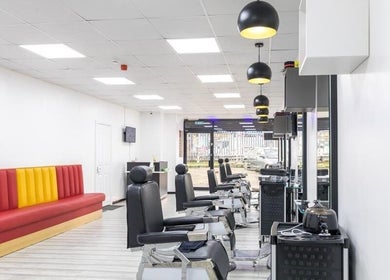 Elegant salon interior at Indulgence Beauty and Hair Salon, Salford, England, GB. Modern chairs and vibrant decor.