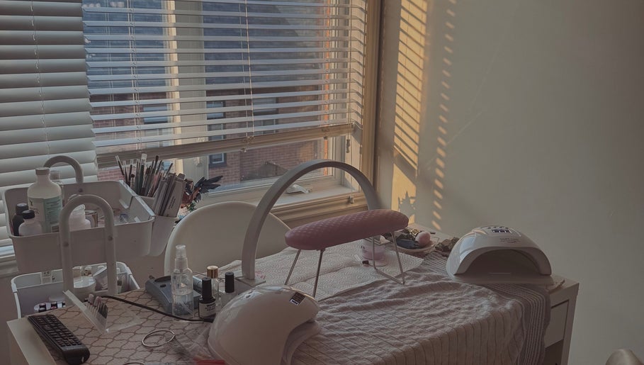 Nail care setup at Micah N Manis in Montréal, Québec, CA with tools and gel lamps by a sunlit window.