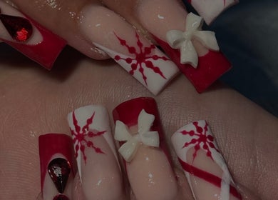Intricate red and white nail art with bows at Micah N Manis, Montréal, Québec, CA.