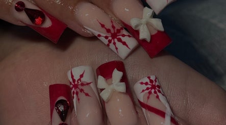 Intricate red and white nail art with bows at Micah N Manis, Montréal, Québec, CA.