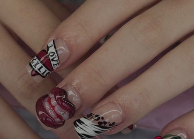 Intricate nail art design at Micah N Manis, Montréal, Québec, CA, featuring bold patterns and vibrant colors.