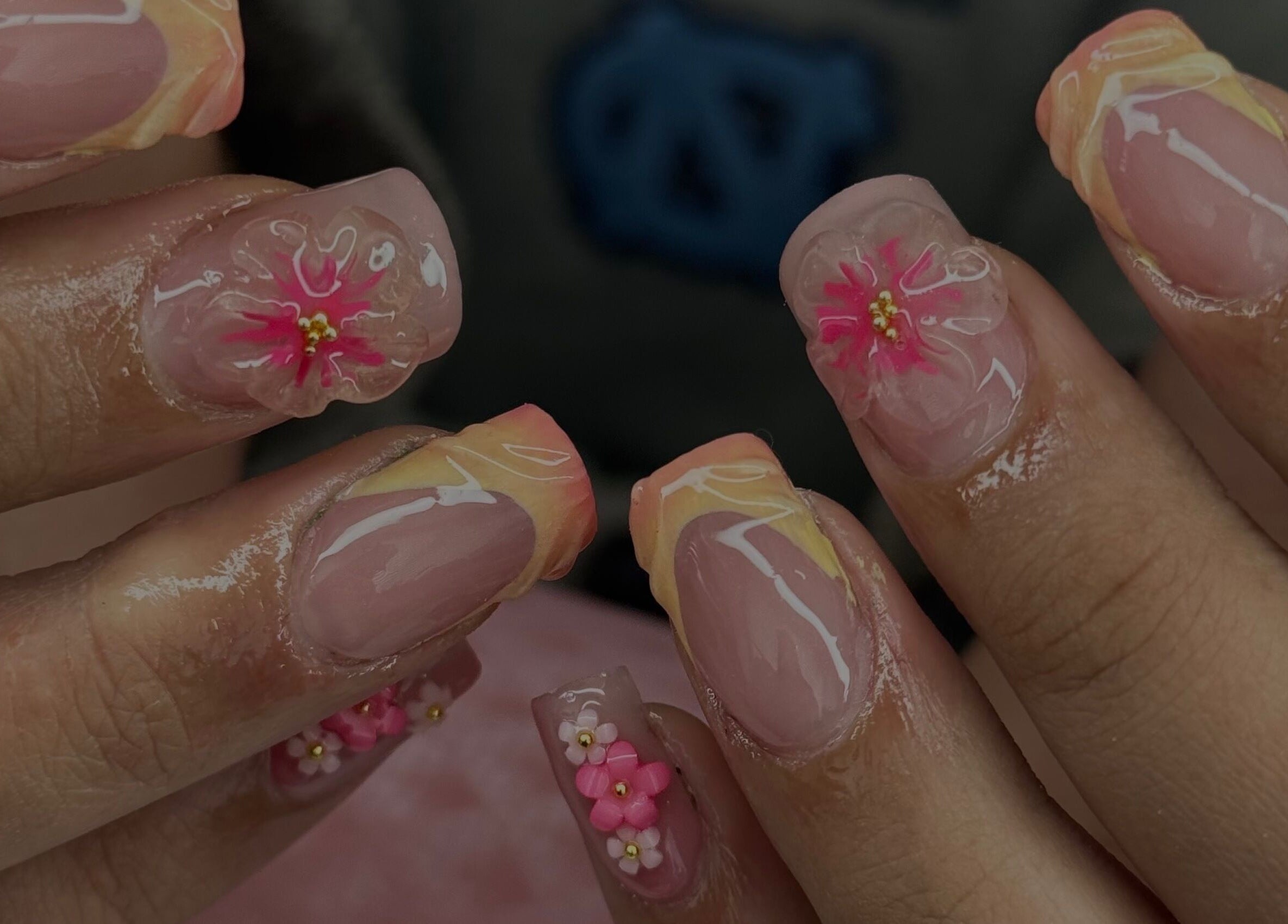 Beautiful floral nail art at Manis & Minks in Montréal, Québec, CA. Vibrant designs on manicured nails.