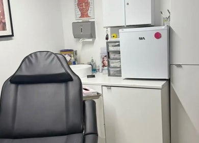 Modern and cozy treatment room at ML Aesthetics in Accrington, England, GB showcasing a comfortable chair.