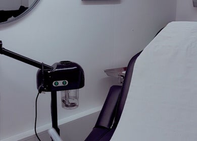 Modern treatment room at ML Aesthetics, Accrington, England, GB, featuring a cozy chair and professional equipment.