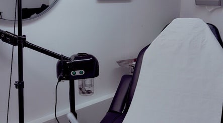Modern treatment room at ML Aesthetics, Accrington, England, GB, featuring a cozy chair and professional equipment.