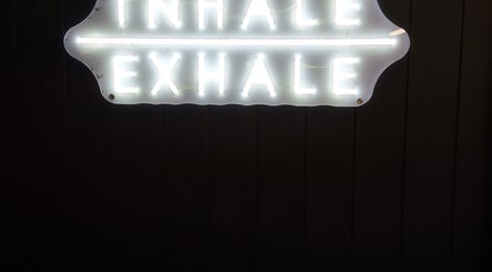 Illuminated 'Inhale Exhale' sign at Fitsom Health, Warriewood, New South Wales, AU inspiring calm and relaxation.
