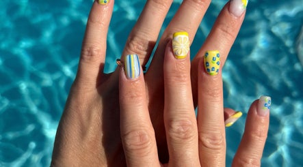 Bright nail art with lemon designs at The Polished Farmgirl, Pembroke, Ontario, CA by a turquoise pool.