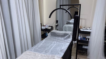 Relaxing treatment room at Rabesa Beauty Bar, Toronto, Ontario, CA with a cozy bed and soft lighting.
