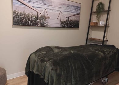 Relaxing massage room at Advanced Massage Therapy, Winnipeg, Manitoba, CA, featuring a cozy bed and serene decor.