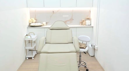Modern treatment room at Bareline Laser, Liverpool, New South Wales, AU with elegant white decor and comfortable chair.