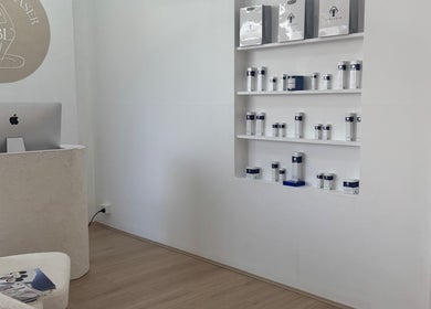 Reception area at Bareline Laser, Liverpool, New South Wales, AU, showcasing product shelves and modern decor.