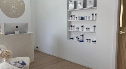 Reception area at Bareline Laser, Liverpool, New South Wales, AU, showcasing product shelves and modern decor.