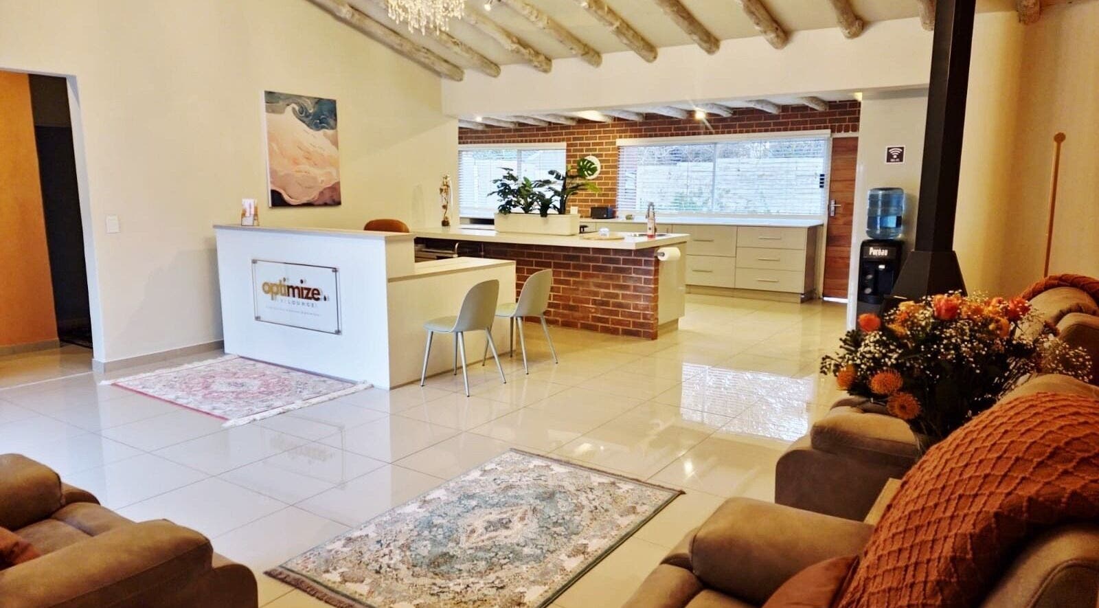 Relaxing interior at Optimize IV Lounge, Randburg, Gauteng, ZA with modern seating and warm decor.