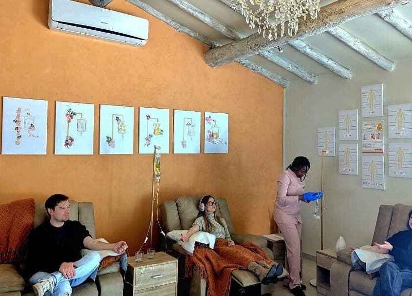 Guests relaxing at Optimize IV Lounge, Randburg, Gauteng, ZA, showcasing wellness treatments in a serene setting.