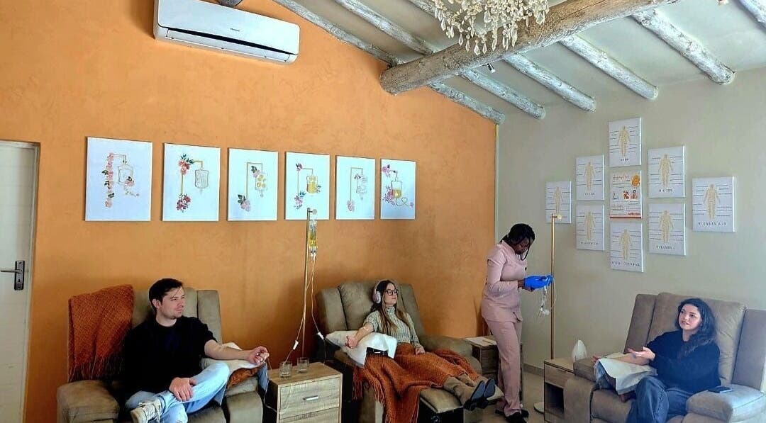 Guests relaxing at Optimize IV Lounge, Randburg, Gauteng, ZA, showcasing wellness treatments in a serene setting.