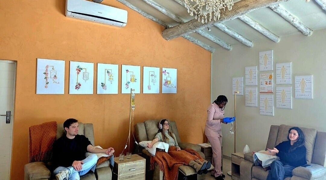 Guests relaxing at Optimize IV Lounge, Randburg, Gauteng, ZA, showcasing wellness treatments in a serene setting.