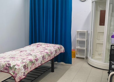 Massage room at Rumah Sihat Senawang, featuring a floral bedspread, located in Seremban, Negeri Sembilan, MY.