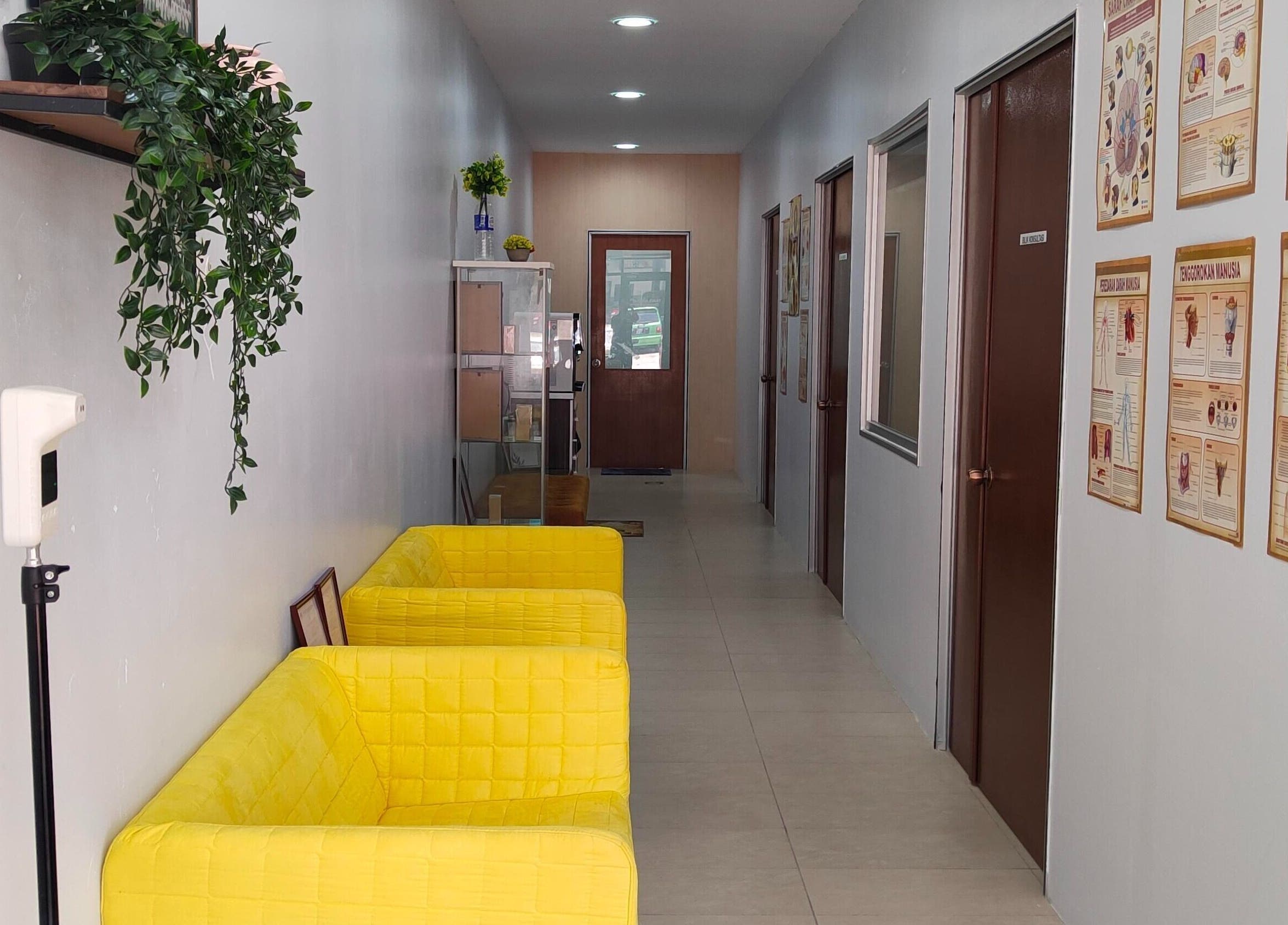 Bright hallway with yellow chairs at Rumah Sihat Senawang, Seremban, Negeri Sembilan, MY. Wellness venue ambiance.