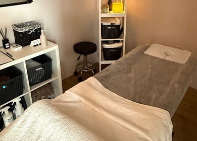Serene massage room at Velora Studio Massage & PMU, Portsmouth, England, GB, offering relaxation and wellness.