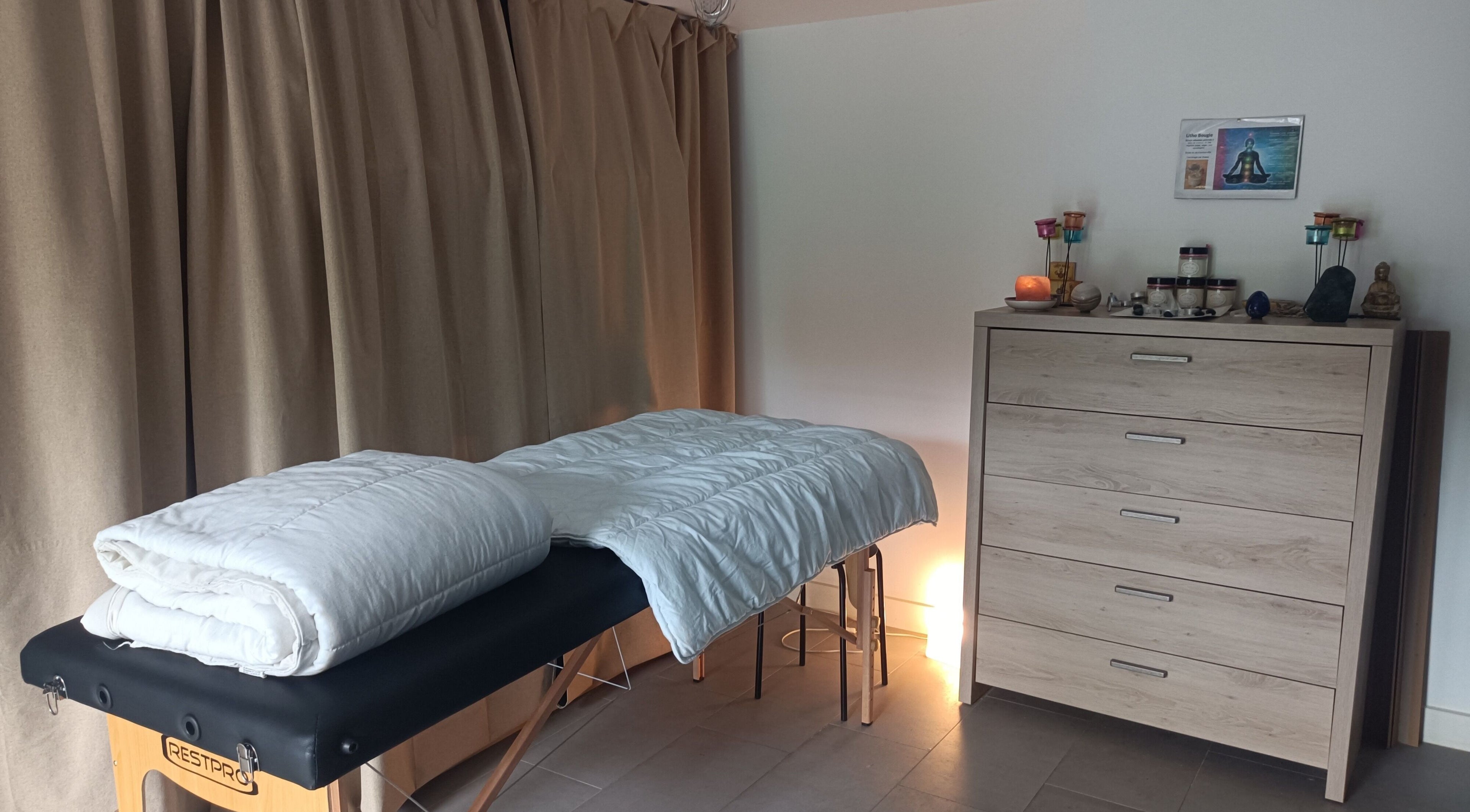 Salle de soins Un Souffle Nouveau à Schaerbeek, Bruxelles, équipée d'une table de massage et de bougies apaisantes.
