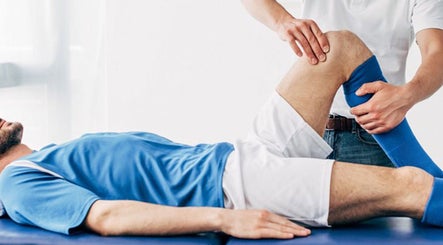 Therapist performs sports therapy on a patient at RMT Sports Therapy, Cross Hands, Wales, GB.