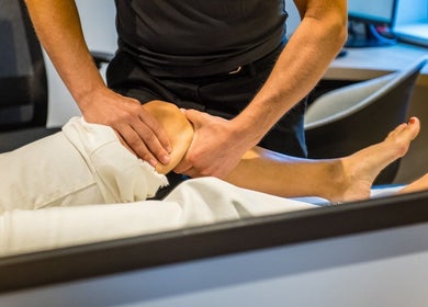 Therapist performing knee massage at RMT Sports Therapy, Cross Hands, Wales, GB.