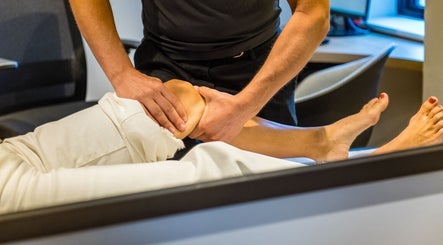 Therapist performing knee massage at RMT Sports Therapy, Cross Hands, Wales, GB.