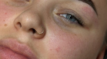 Close-up of glowing skin with a nose ring at BeautyByElls, Riddings, England, GB.